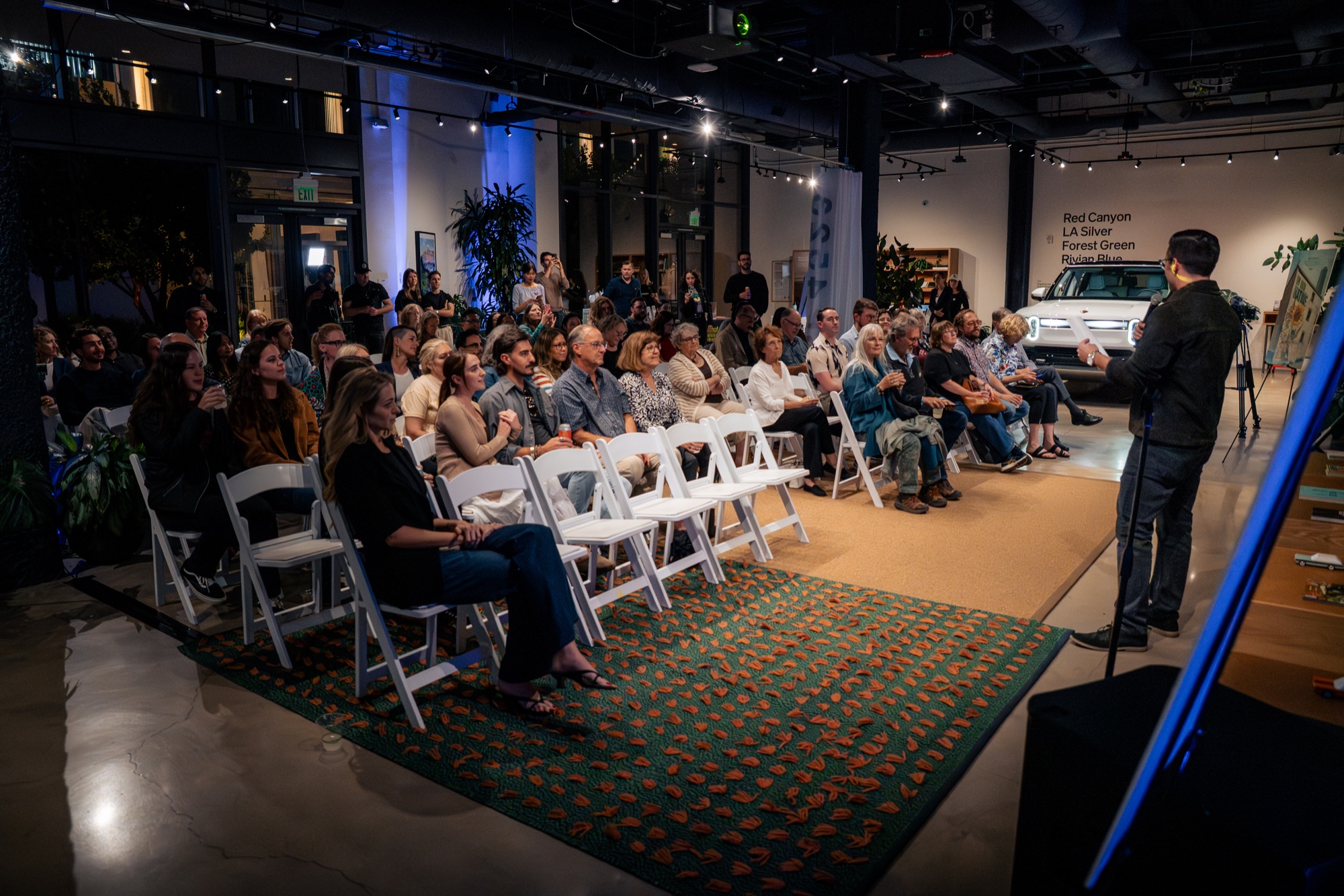 Seated audience listening to a speaker at an In Our Nature screening.