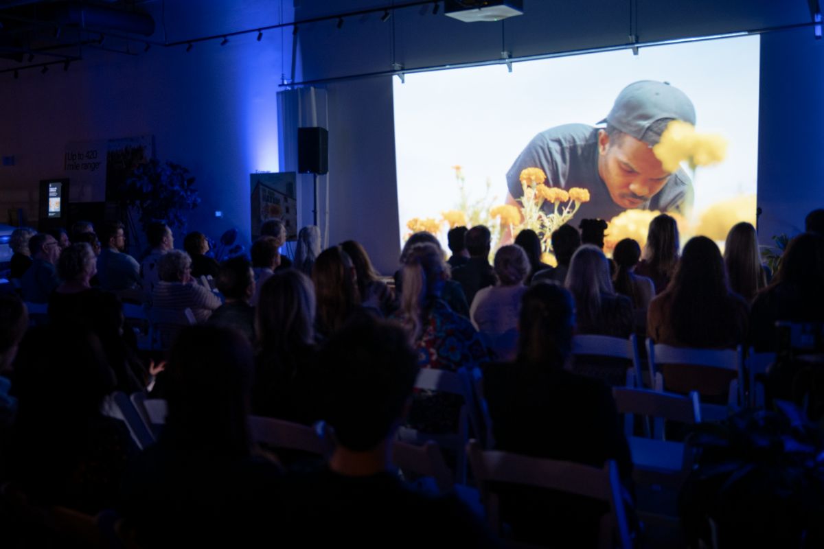 Audience watching In Our Nature on a large screen